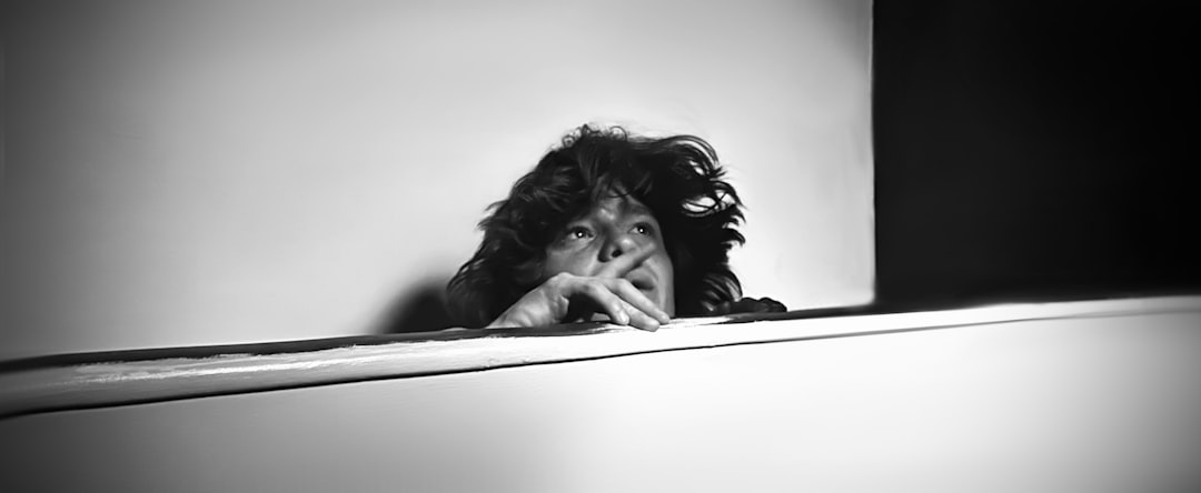 Black and white portrait of a woman with curly hair.