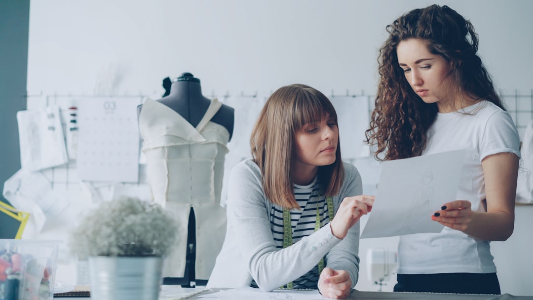 Fashion designers discuss design plans in their studio.