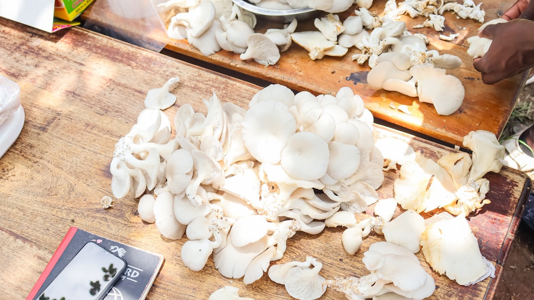 A person chopping mushrooms on a cutting board