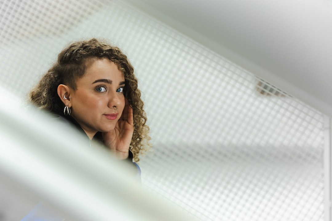 Young woman poses looking over her shoulder.