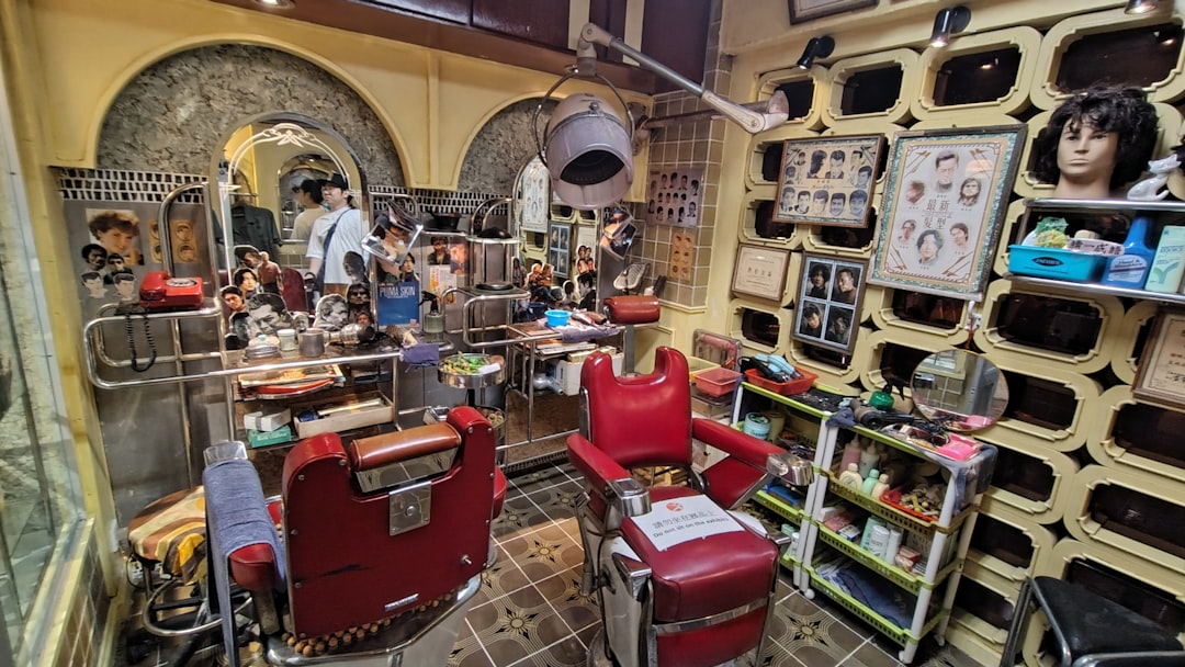 Vintage barber shop interior with red chairs and dryers