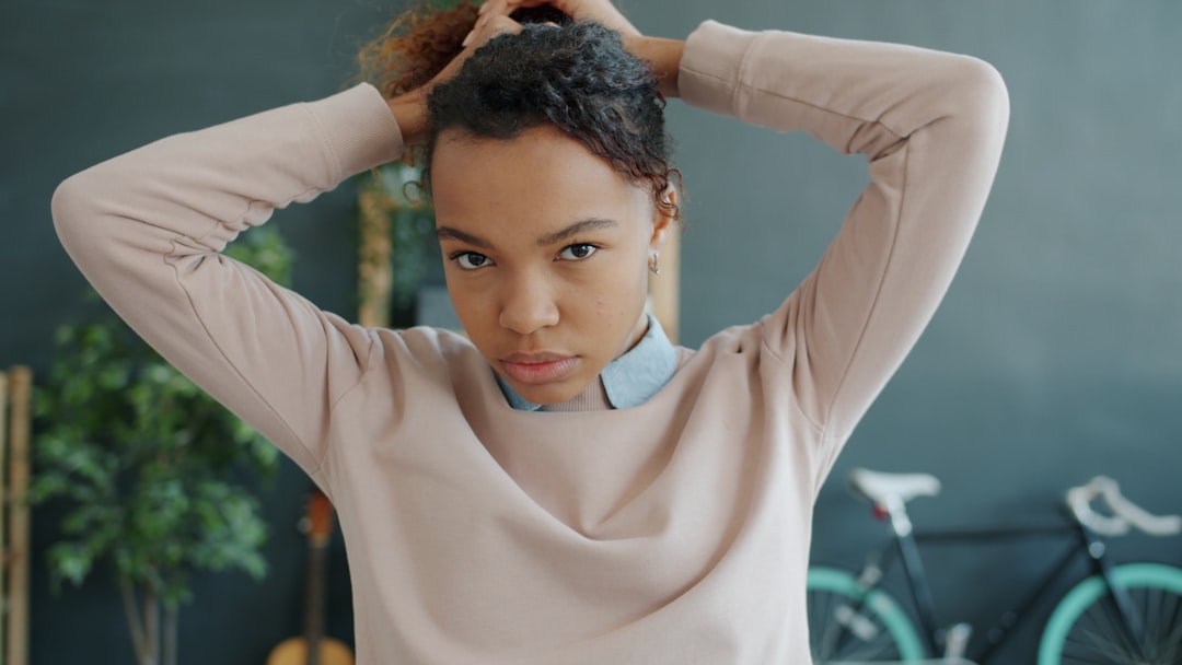 Young woman tying her hair up