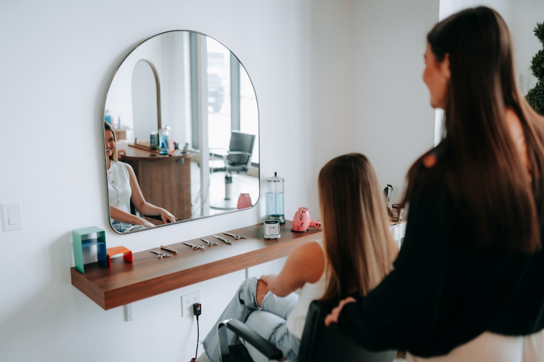 A woman gets her hair styled at a salon.