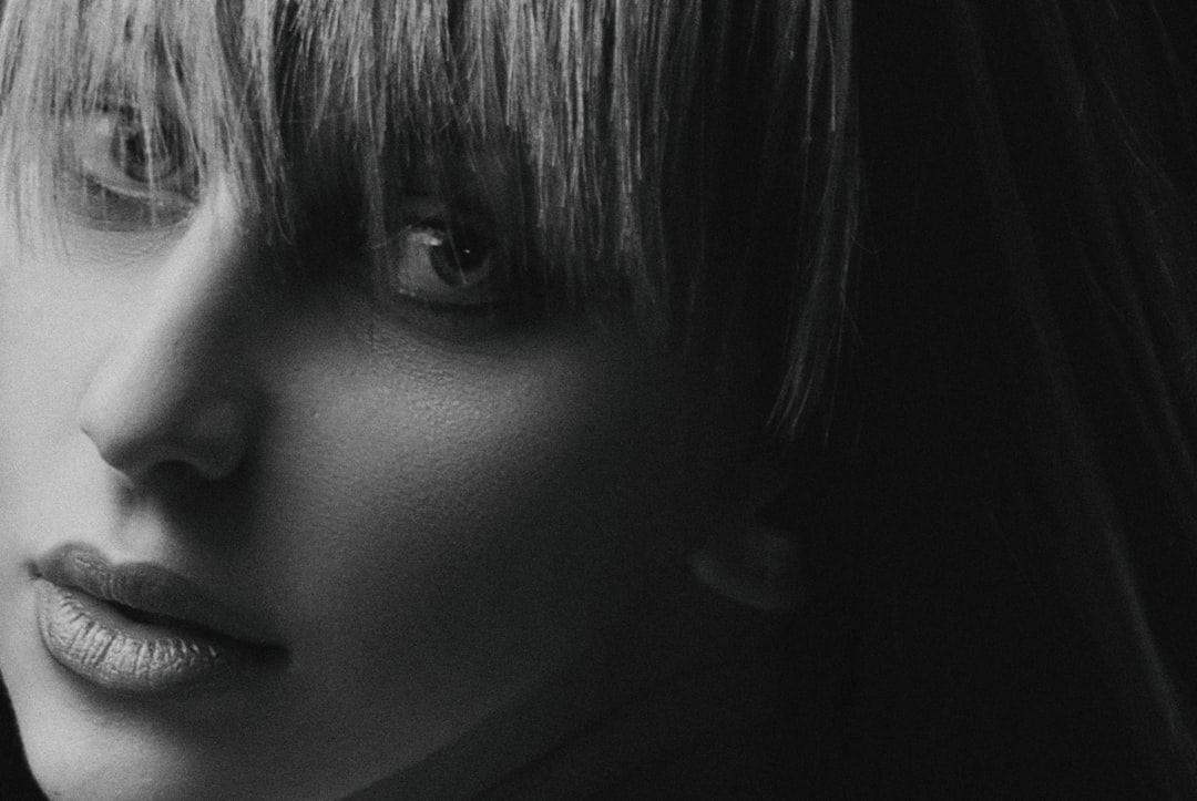 greyscale photo of woman with bangs