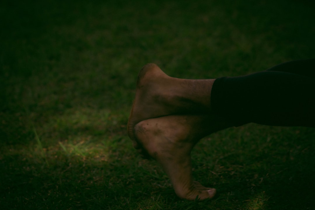 a close up of a person's legs in the grass