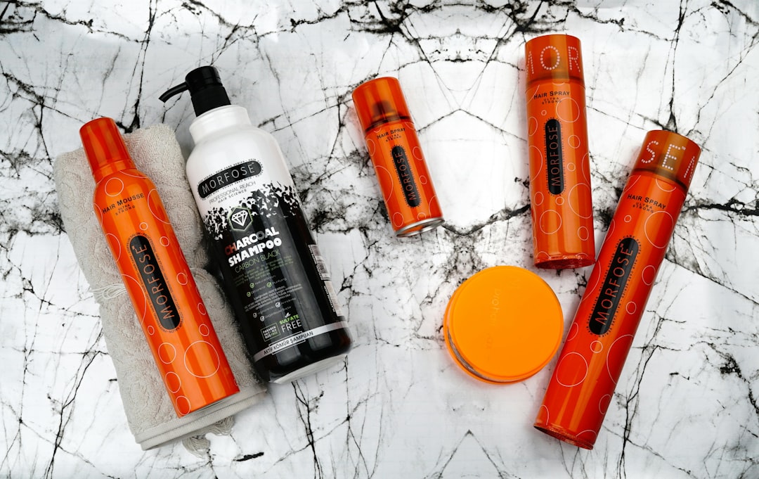 Beauty products are arranged on a marble surface.