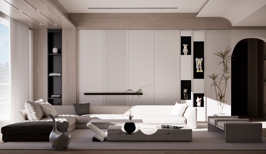 a living room with a white couch and a black chair