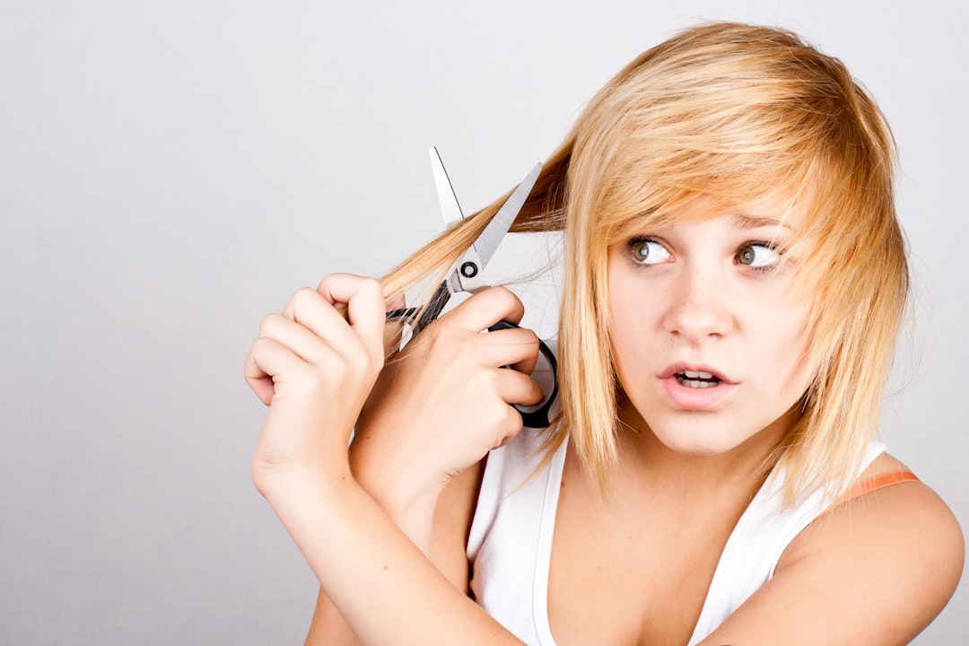 A woman holding a pair of scissors in her hands