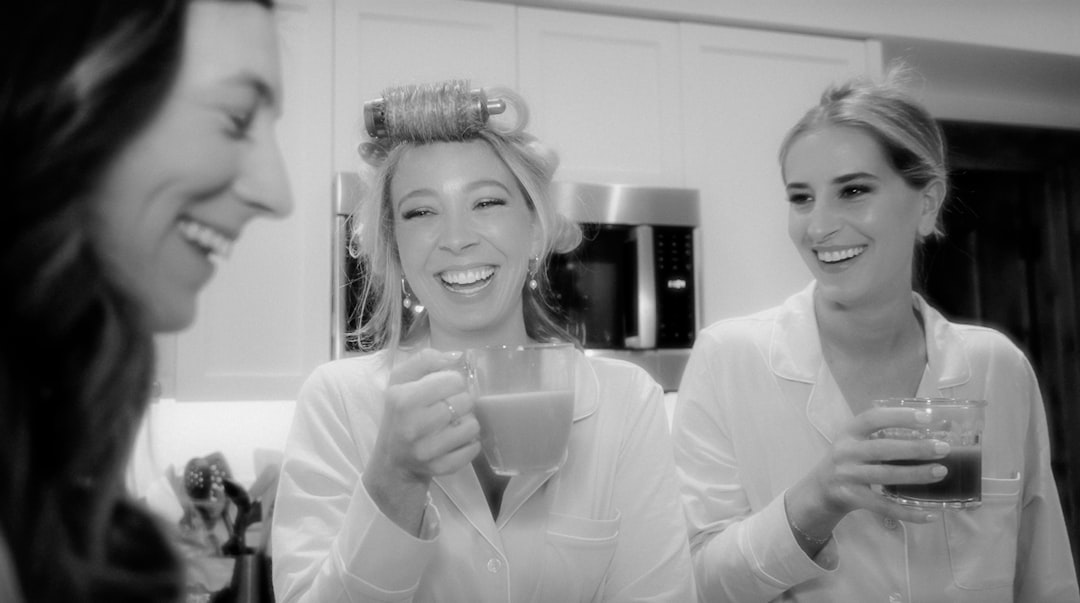 a group of women standing next to each other in a kitchen