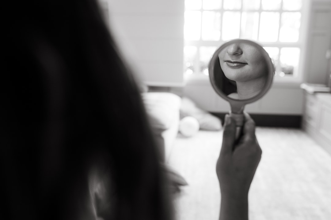 a woman holding a hair dryer in front of her face
