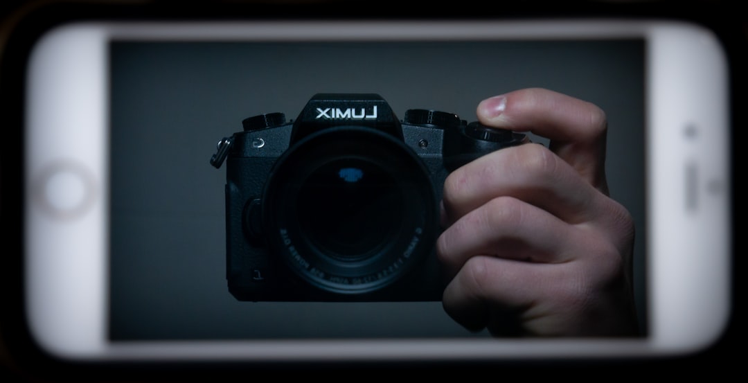black nikon dslr camera on persons hand