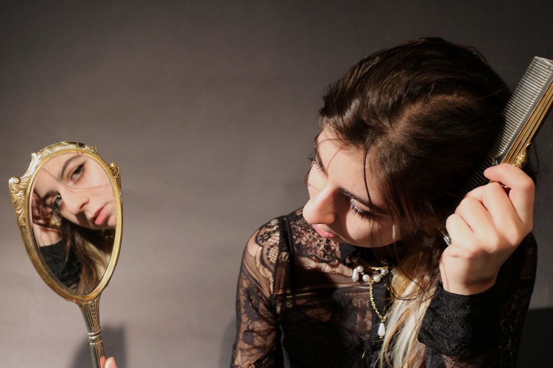 A woman looking at herself in the mirror