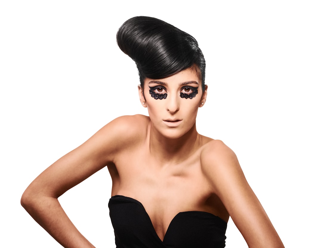 a woman with black makeup and a black dress