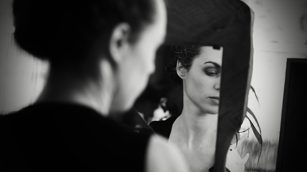 a woman looking at herself in the mirror