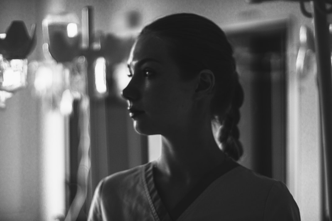 Young woman in scrubs with braided hair