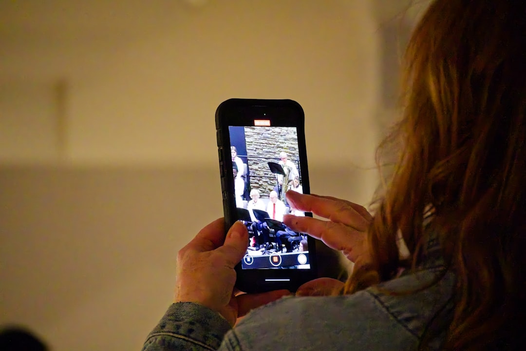 Woman holding a smartphone and taking a picture