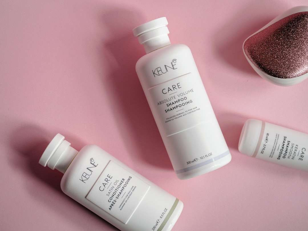 a bottle of keune care next to a container of hair care
