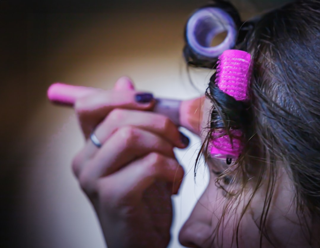 a close up of a woman brushing her hair