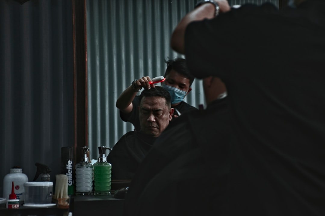 photo of man having a haircut