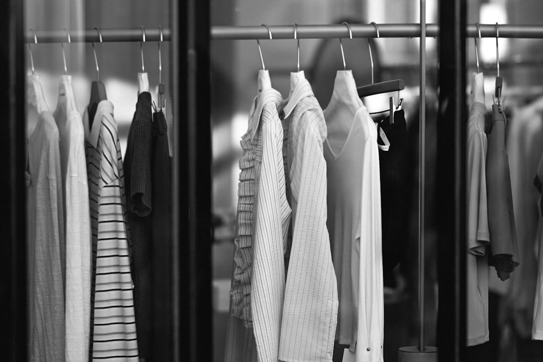 Clothes hanging on a rack in a store.