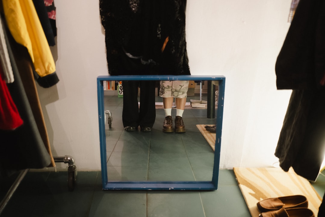 A mirror shows feet.