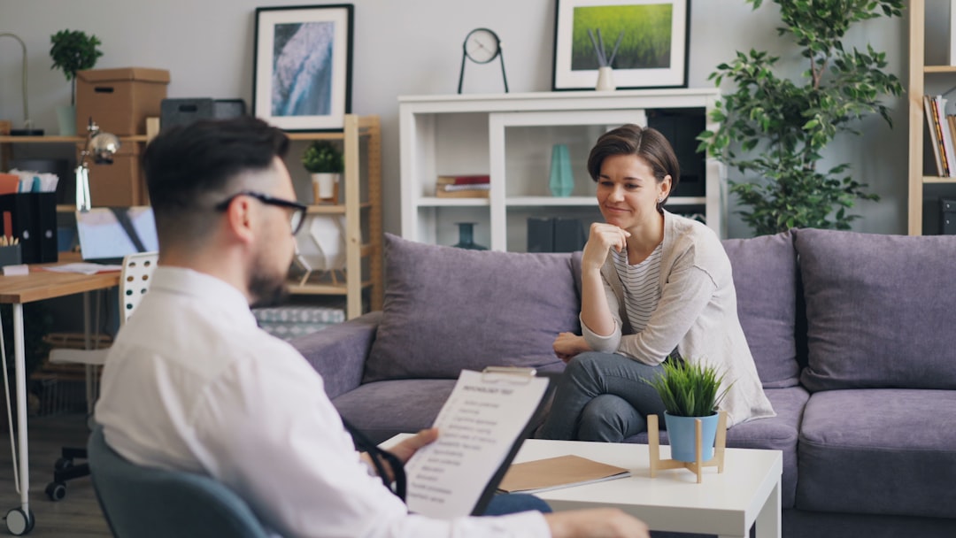 a woman sitting on a couch talking to a man